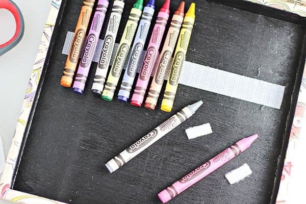 Genius! Make an art box and use VELCRO to keep crayons in place!