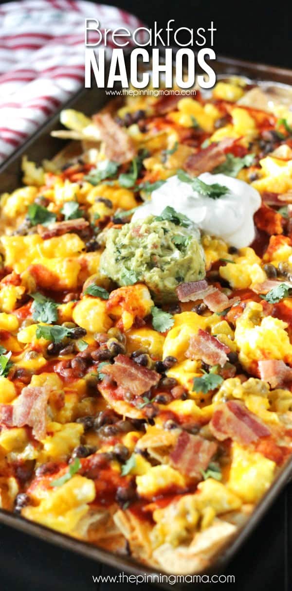 Breakfast Nachos Recipe - This quick and easy breakfast recipe will become a quick favorite if you love nachos as much as we do!  Crispy tortilla chips are layered with eggs, bacon, enchilada sauce and a few other ingredients to make a breakfast to feed 2 or feed a crowd in just minutes.