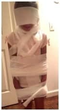 kids making mummy's with toilet paper