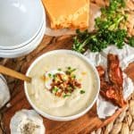 Instant Pot Cauliflower Soup topped with sour cream , cheese and bacon